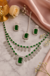 AD jewellery set with green stones – necklace, earrings, and maang tikka bridal collection