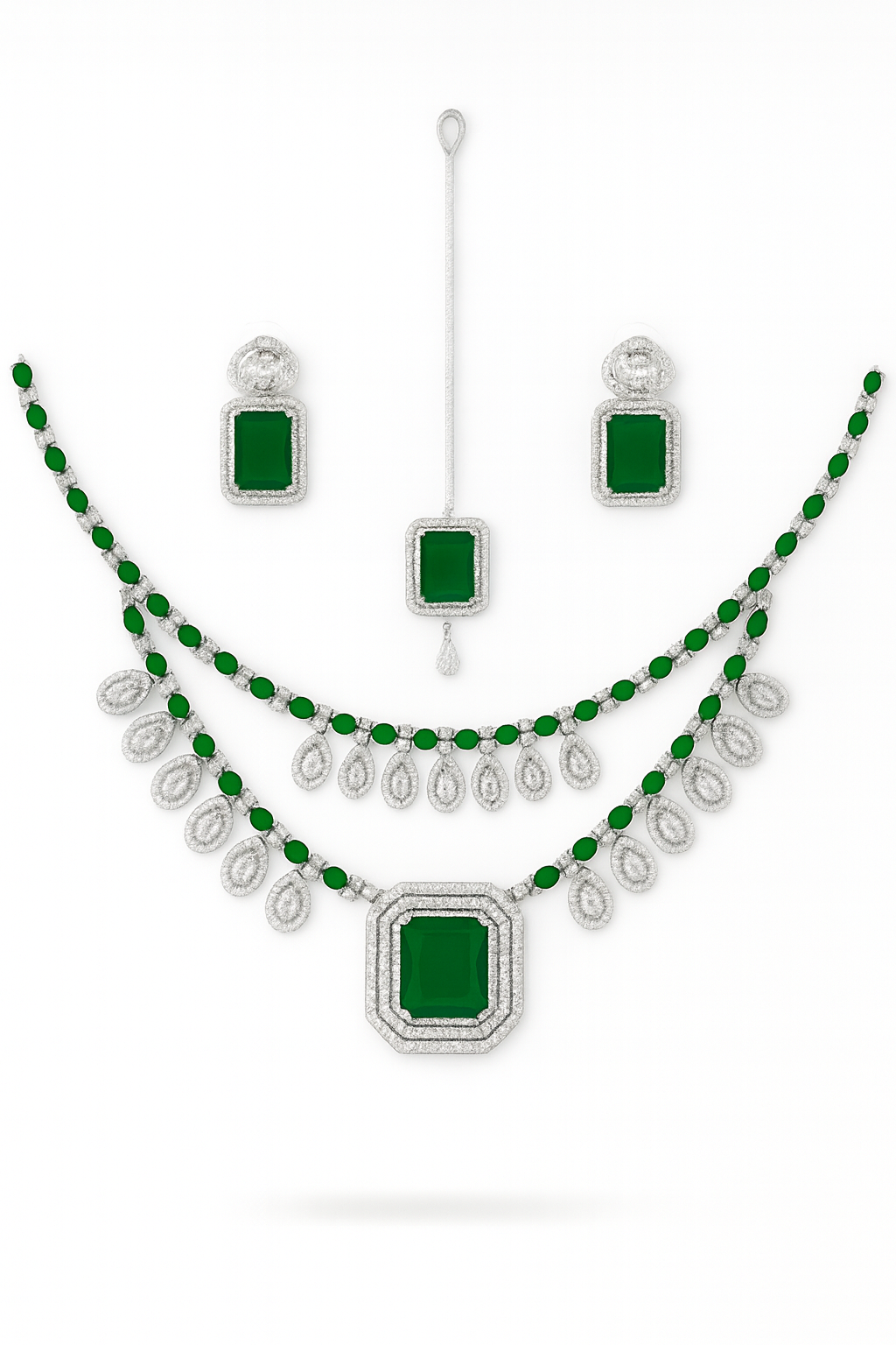 "American diamond necklace set with green stones, bridal jewellery with earrings and maang tikka, premium artificial wedding jewellery by TAPASVINI."