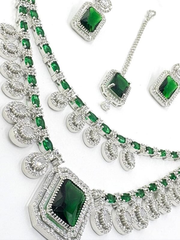 “American Diamond bridal jewellery set with green stones – necklace, earrings, and maang tikka”