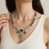 AD Stone Jewellery Set with green stones in nano setting – necklace, earrings, and maang tikka bridal collection by Tapasvini
